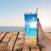 Photo of a woman holding her personalized tumbler with name on outdoor wood table – perfect beachy moment captured.
